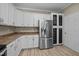 Kitchen featuring stainless steel refrigerator, decorative pantry, and hardwood floors at 359 Punch Hill Farm Rd, Rougemont, NC 27572