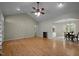 Bright, open living room with wood floors, ceiling fan, and an adjacent dining area at 359 Punch Hill Farm Rd, Rougemont, NC 27572