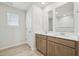 Bathroom featuring a double vanity and a window with blinds at 3841 Rosebush Dr, Zebulon, NC 27597