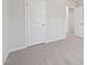A bedroom featuring neutral carpet, white trim, and two white doors at 3841 Rosebush Dr, Zebulon, NC 27597