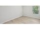A well-lit bedroom featuring modern vinyl flooring and a window with natural light at 3841 Rosebush Dr, Zebulon, NC 27597