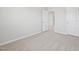 A bedroom featuring neutral carpet, white trim, and two white doors at 3841 Rosebush Dr, Zebulon, NC 27597