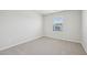 A bedroom featuring neutral carpet, white trim, and a window with blinds at 3841 Rosebush Dr, Zebulon, NC 27597