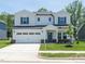 Charming two-story home with a two-car garage, manicured lawn, and inviting front entrance at 3841 Rosebush Dr, Zebulon, NC 27597