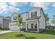 Well-manicured front yard and a two-story home with an attached two car garage at 3841 Rosebush Dr, Zebulon, NC 27597