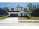 Inviting two-story home with a spacious driveway and a two car garage on a manicured front lawn at 3841 Rosebush Dr, Zebulon, NC 27597