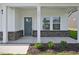 Inviting front porch with decorative columns and brick accents and address number displayed at 3841 Rosebush Dr, Zebulon, NC 27597