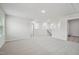 Upstairs hallway features neutral paint, carpet, and a view of the stairway and bonus room at 3841 Rosebush Dr, Zebulon, NC 27597