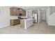 Open-concept kitchen features a center island, stainless steel appliances, and abundant cabinet space at 3841 Rosebush Dr, Zebulon, NC 27597