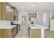 Expansive kitchen area with stainless steel appliances and view into the connected living space at 3841 Rosebush Dr, Zebulon, NC 27597