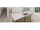 Well-lit kitchen island featuring quartz countertops with cabinets and a stainless steel dishwasher at 3841 Rosebush Dr, Zebulon, NC 27597