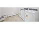 Bright laundry room with modern washer and dryer units and flooring at 3841 Rosebush Dr, Zebulon, NC 27597