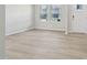 Bright living room featuring modern flooring, windows, and neutral wall color with ample natural light at 3841 Rosebush Dr, Zebulon, NC 27597