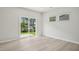 Sunlit room boasts sliding glass doors with backyard view and light wood flooring at 3841 Rosebush Dr, Zebulon, NC 27597