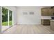 Bright, open living room with sliding glass doors to the outdoors and light wood flooring at 3841 Rosebush Dr, Zebulon, NC 27597