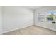 Bright room featuring modern flooring, neutral wall color, and natural light streaming through the windows at 3841 Rosebush Dr, Zebulon, NC 27597