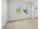 Bright living room featuring modern flooring, windows, and neutral wall color with ample natural light at 3841 Rosebush Dr, Zebulon, NC 27597