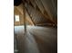 Large unfinished attic space offers potential for customization and extra storage with natural light from a window at 3920 Cedar Knolls Drive Dr # 18, Youngsville, NC 27596
