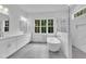 Modern bathroom with double vanity, soaking tub, and natural light from window at 3920 Cedar Knolls Drive Dr # 18, Youngsville, NC 27596