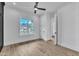 Bright bedroom featuring a ceiling fan, hardwood floors, and a view of the exterior at 3920 Cedar Knolls Drive Dr # 18, Youngsville, NC 27596