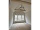 Bright bedroom features a vaulted ceiling, wooden beams, a modern chandelier, and a window with a beautiful view at 3920 Cedar Knolls Drive Dr # 18, Youngsville, NC 27596