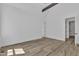 Bright bedroom with hardwood floors, white walls, and an open doorway at 3920 Cedar Knolls Drive Dr # 18, Youngsville, NC 27596