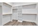Spacious walk-in closet with custom shelving and wood trim at 3920 Cedar Knolls Drive Dr # 18, Youngsville, NC 27596