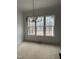 Bright dining room with a modern chandelier and a large window overlooking the backyard at 3920 Cedar Knolls Drive Dr # 18, Youngsville, NC 27596