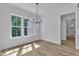 Bright dining room with hardwood floors, a chandelier, and large windows overlooking the yard at 3920 Cedar Knolls Drive Dr # 18, Youngsville, NC 27596