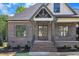 Close up of the front entrance with brick steps, iron railing, and wooden double doors at 3920 Cedar Knolls Drive Dr # 18, Youngsville, NC 27596