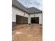 Attached three-car garage with brick and siding exterior, offering ample space and curb appeal at 3920 Cedar Knolls Drive Dr # 18, Youngsville, NC 27596