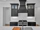 Stylish kitchen boasts black cabinets, a white backsplash, and stainless steel appliances at 3920 Cedar Knolls Drive Dr # 18, Youngsville, NC 27596