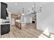 Gourmet kitchen with modern appliances, hardwood floors, island, and a view of the living room at 3920 Cedar Knolls Drive Dr # 18, Youngsville, NC 27596