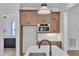 Kitchen island has white countertop and is surrounded by hardwood cabinets and stainless steel appliances at 3920 Cedar Knolls Drive Dr # 18, Youngsville, NC 27596