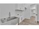 Well-lit laundry room with stainless steel sink and white cabinets at 3920 Cedar Knolls Drive Dr # 18, Youngsville, NC 27596