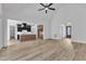 Open-concept living room with hardwood floors, high ceiling, and access to kitchen area at 3920 Cedar Knolls Drive Dr # 18, Youngsville, NC 27596