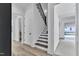 Staircase with dark wood steps, a modern black metal railing, and wood flooring at 3920 Cedar Knolls Drive Dr # 18, Youngsville, NC 27596