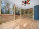 Spacious wooden back porch overlooking a lush wooded area, with a ceiling fan at 42 Ponchartrain St, Fuquay Varina, NC 27526