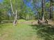 Spacious backyard featuring a well-maintained lawn, wooden fence, and steps at 42 Ponchartrain St, Fuquay Varina, NC 27526