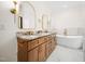 Bright bathroom with double vanity, granite countertops, and a freestanding bathtub with gold fixtures at 42 Ponchartrain St, Fuquay Varina, NC 27526