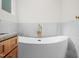 Soaking tub features gold faucet, marble walls and a light for a luxurious feel at 42 Ponchartrain St, Fuquay Varina, NC 27526