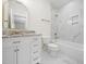 Bathroom featuring a granite vanity, white cabinets, a marble shower, and gold fixtures at 42 Ponchartrain St, Fuquay Varina, NC 27526