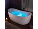 Modern bathtub with glowing blue water and adjacent glass shower at 42 Ponchartrain St, Fuquay Varina, NC 27526