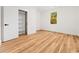 Bedroom with wood floors, white trim, closet with shelving, and natural light from the window at 42 Ponchartrain St, Fuquay Varina, NC 27526
