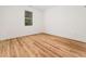 Bedroom with wood floors, natural light from the window, and white trim at 42 Ponchartrain St, Fuquay Varina, NC 27526