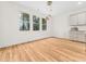 Bright dining area features wood flooring, three windows, and modern light fixtures, complemented by built in storage at 42 Ponchartrain St, Fuquay Varina, NC 27526