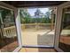 View from inside the home, leading to an exterior deck with scenic views of the tranquil lake and trees at 42 Ponchartrain St, Fuquay Varina, NC 27526