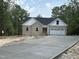 New construction features stone and vinyl siding, a two-car garage and a concrete driveway at 42 Ponchartrain St, Fuquay Varina, NC 27526