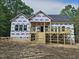 New home showing the back with a large, unfinished deck overlooking the wooded lot at 42 Ponchartrain St, Fuquay Varina, NC 27526