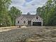 New construction with dark roof and house wrap with trees surrounding the house at 42 Ponchartrain St, Fuquay Varina, NC 27526